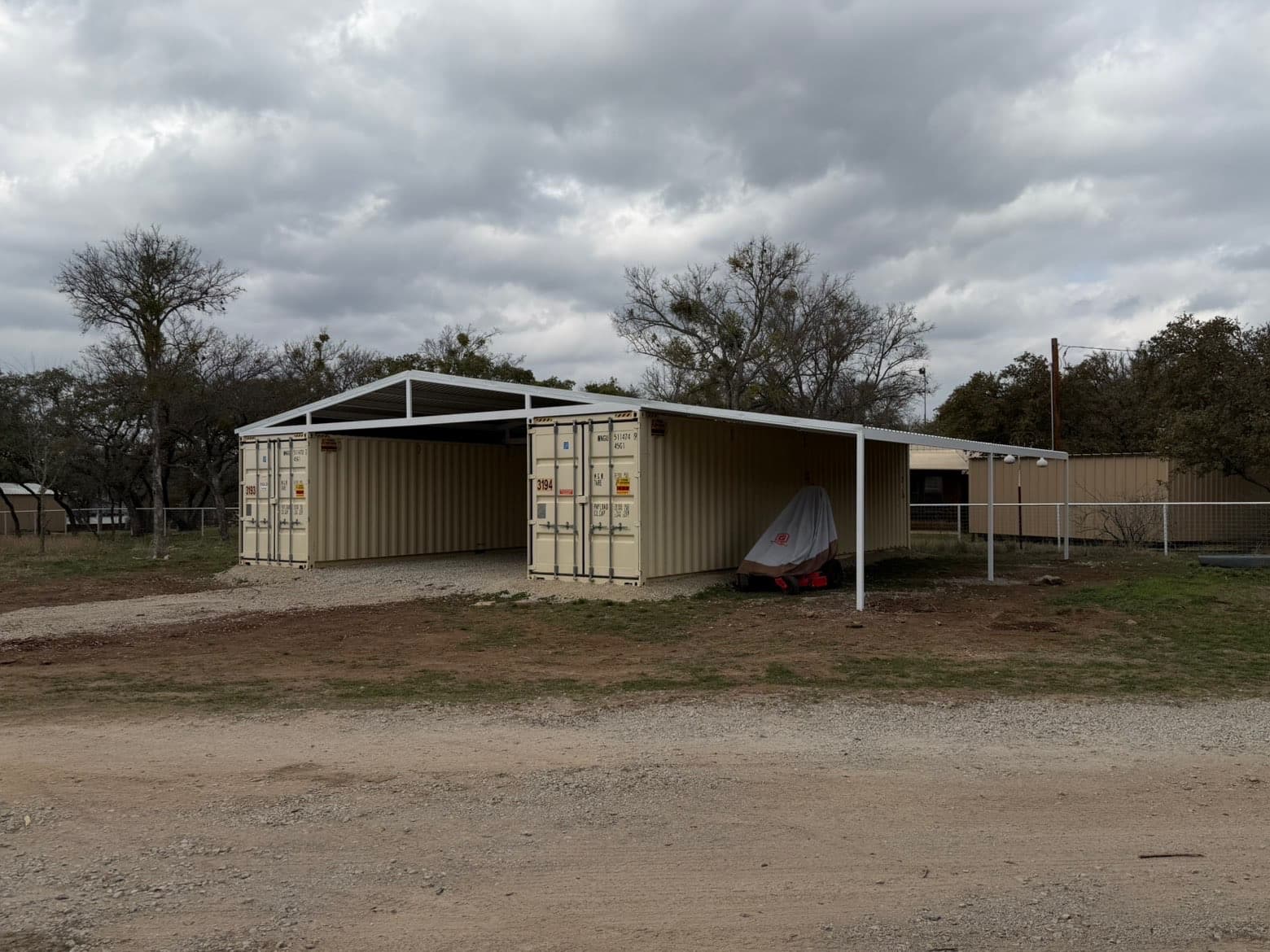 Completed container-style metal building with covered bays